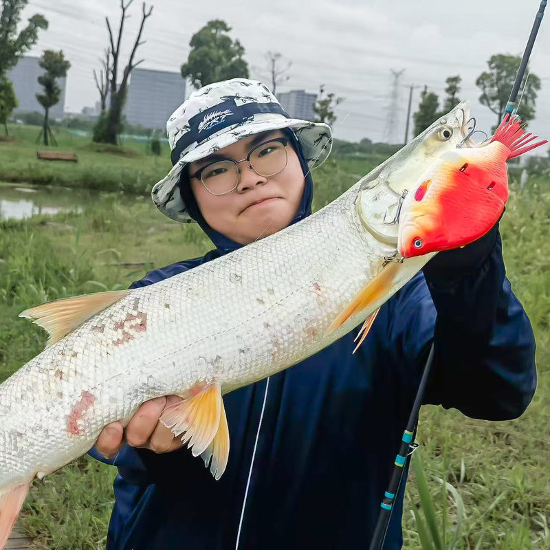 Person holding a large fish with a out4fish swimbaie in an outdoor setting